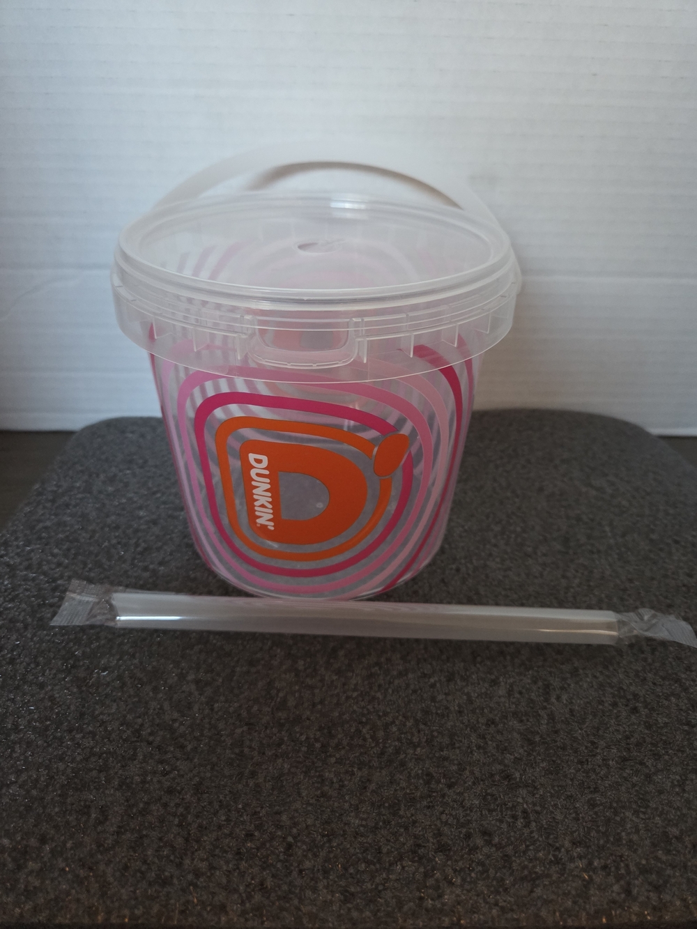 Dunkin' 48 oz. bucket cup with unopened straw.